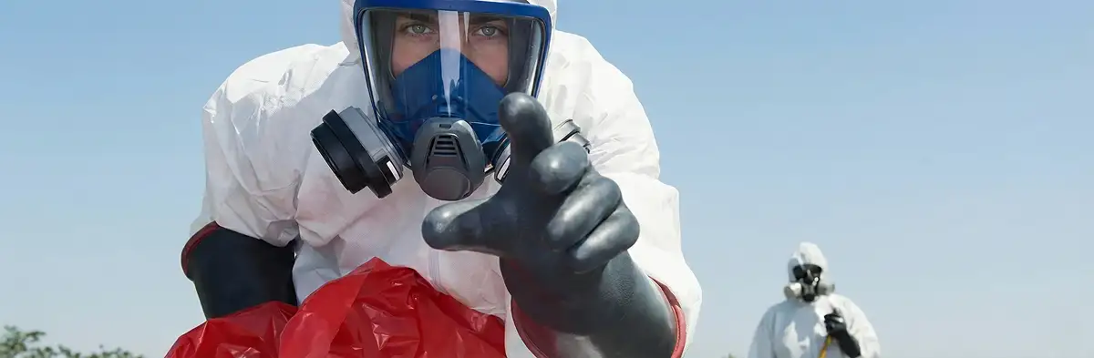 sewage clean up technician wearing protective gear handling biohazard materials in Phoenix, AZ