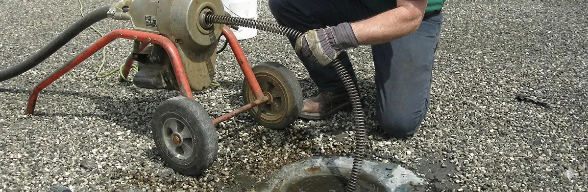 sewer rodding technician actively removing blockages from a sewer line in Phoenix, AZ